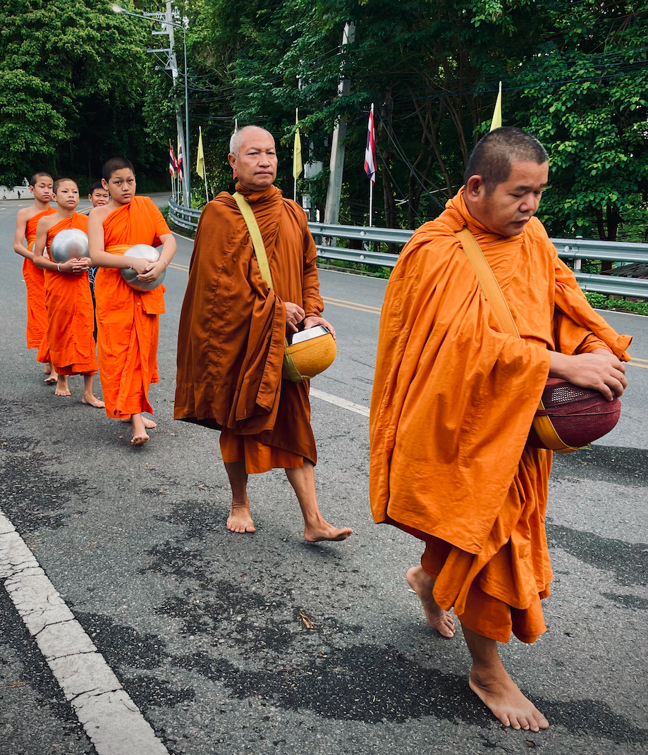 Monks make their walk into town to collect offerings in return for a blessing.